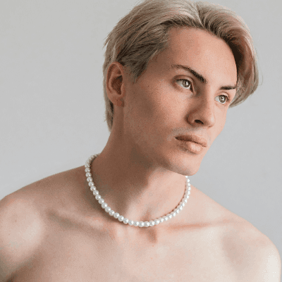 a man with a pearl necklace on his neck