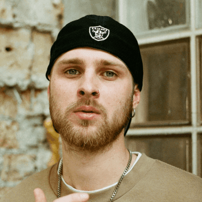 man in brown crew neck shirt wearing black cap