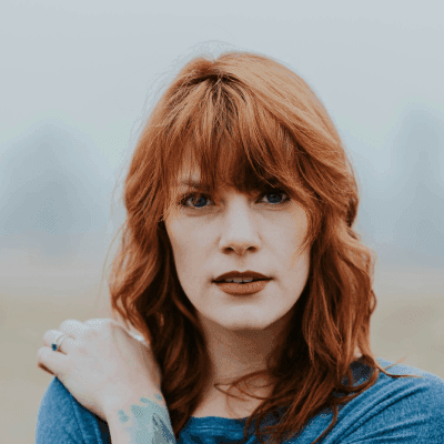 woman in blue raglan shirt shallow focus photography