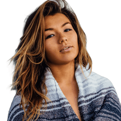 woman with black, white, and grey blanket leaning on wall with no lifeguard on duty signage