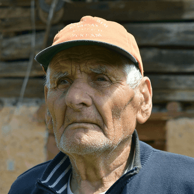 man in black zip up jacket and brown hat
