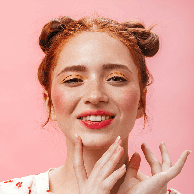 a woman posing with her hands on her face