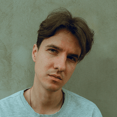 a man sitting down with his hands on his hips