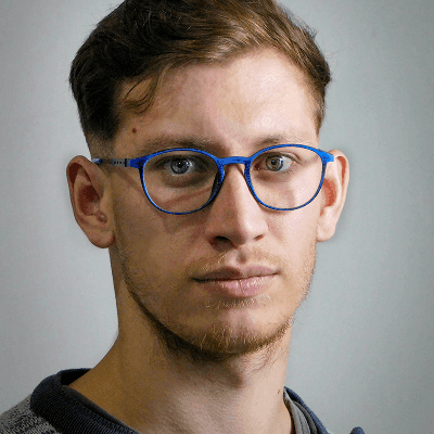 Man with glasses looking directly at the camera