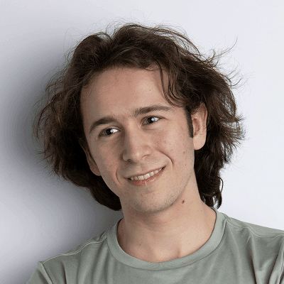 A man with his arms crossed posing for a picture