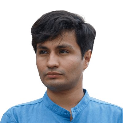 A man in a blue collared shirt stands outdoors.