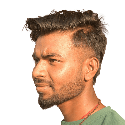 A man in a green shirt standing in front of a building