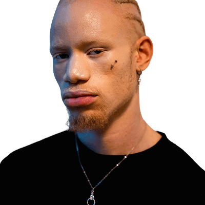 Man with braided hair and beard wearing necklace